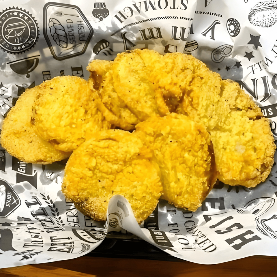 Golden fried fish fillets from Delta Fish Market Bar & Grill, served on branded paper.